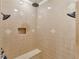 Tiled shower showcasing dual shower heads, a built-in seat, and decorative tile accents at 2554 Emerald Dr, Jonesboro, GA 30236