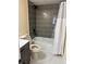 Bathroom featuring modern gray tiled walls, a shower-tub combo, and stylish vanity at 109 Thirkield Se Ave, Atlanta, GA 30315