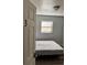A simple bedroom with an unmade bed, hardwood floors, and plenty of natural light from the window at 109 Thirkield Se Ave, Atlanta, GA 30315