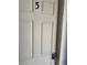 This is a door with a large number five on it. The door is white and has a keypad lock at 109 Thirkield Se Ave, Atlanta, GA 30315
