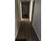 Hallway with gray walls and dark wood-look flooring leading to a bright front door at 109 Thirkield Se Ave, Atlanta, GA 30315