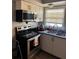 Cozy kitchen featuring stainless steel appliances, a double sink, and white cabinets at 109 Thirkield Se Ave, Atlanta, GA 30315
