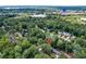 Aerial view of property surrounded by mature trees, neighborhood, and highways at 2958 Cravey Ne Dr, Atlanta, GA 30345