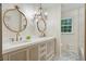 Modern bathroom featuring double sinks, decorative mirrors, and a combination shower and bathtub at 2958 Cravey Ne Dr, Atlanta, GA 30345