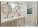 Stylish bathroom featuring double sinks, decorative mirrors, and elegant light fixtures at 2958 Cravey Ne Dr, Atlanta, GA 30345