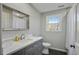 Bathroom with a vanity sink, a framed mirror and a window that provides natural light at 2958 Cravey Ne Dr, Atlanta, GA 30345