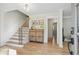 Inviting home foyer with hardwood floors, wooden staircase with iron spindles, and view to other rooms at 2958 Cravey Ne Dr, Atlanta, GA 30345