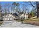 Beautiful two-story home with a large driveway, dormer windows, neutral colors, and mature trees at 2958 Cravey Ne Dr, Atlanta, GA 30345