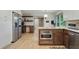 Kitchen with stainless steel appliances, custom cabinetry, hardwood floors, and view into adjoining room at 2958 Cravey Ne Dr, Atlanta, GA 30345