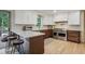 Modern kitchen with stainless steel appliances, an island with seating, light countertops and hardwood floors at 2958 Cravey Ne Dr, Atlanta, GA 30345