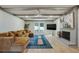 Cozy living room featuring hardwood floors, fireplace, ceiling fan and large windows at 2958 Cravey Ne Dr, Atlanta, GA 30345