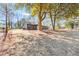 A view of the gray house surrounded by trees and lawn at 4251 Canby Ln, Decatur, GA 30035