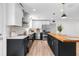 Modern kitchen featuring white cabinets, stainless appliances, and a stylish black island at 4251 Canby Ln, Decatur, GA 30035