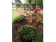 Backyard with a wooden fence and a variety of beautiful colorful plants and flowers at 4860 Roswell Mill Dr, Alpharetta, GA 30022