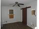 The bedroom has wood-look flooring, natural light, a window, and a modern sliding closet door at 7 Whatley Se St, Atlanta, GA 30315