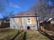 Rear view of a home with a grassy yard and access stairs at 7 Whatley Se St, Atlanta, GA 30315