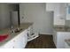 Kitchen featuring granite countertops, wood-look flooring, and stainless steel double sinks at 7 Whatley Se St, Atlanta, GA 30315