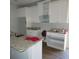 Unfinished kitchen with white cabinets, granite countertops, and stainless steel sink at 7 Whatley Se St, Atlanta, GA 30315