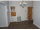 Living room features wood-look flooring, a modern chandelier, and boarded up window at 7 Whatley Se St, Atlanta, GA 30315