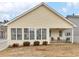 Exterior of home with a porch and outdoor seating in backyard, enhanced by lovely landscaping at 740 Azalea Ave, Mcdonough, GA 30253