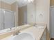 Bathroom with double sinks, a large mirror, and a shower behind glass doors, all with floral wallpaper at 740 Azalea Ave, Mcdonough, GA 30253