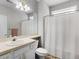 Cozy bathroom with shower and tub combo, light gray cabinets and patterned wallpaper at 740 Azalea Ave, Mcdonough, GA 30253