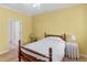 Bedroom features wood floors, neutral walls, and a white bed cover for a calm and inviting space at 740 Azalea Ave, Mcdonough, GA 30253