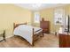 Bright bedroom with wooden floors, ceiling fan, large windows, and classic wood furniture at 740 Azalea Ave, Mcdonough, GA 30253