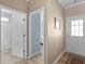Bright hallway with entry to bathroom and bedroom, showcasing hardwood floors and neutral wall color at 740 Azalea Ave, Mcdonough, GA 30253