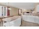 The spacious kitchen includes an island, white cabinets, and a sink under the kitchen window at 740 Azalea Ave, Mcdonough, GA 30253