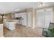 Open kitchen and eat-in area feature white cabinets and appliances, and a kitchen island at 740 Azalea Ave, Mcdonough, GA 30253