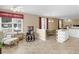 Open living space connecting the kitchen and sunroom with lots of natural light at 740 Azalea Ave, Mcdonough, GA 30253