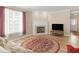 Bright living room with a fireplace, large window, and comfortable seating, creating a welcoming space at 740 Azalea Ave, Mcdonough, GA 30253