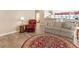 A warm living room features a sofa, armchair, side table, and a decorative round rug at 740 Azalea Ave, Mcdonough, GA 30253