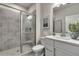 Full bathroom featuring a shower with glass door, a decor mirror, and modern vanity at 1696 Lansmere Sw St, Marietta, GA 30008