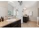 Bright bathroom featuring dual sinks, a large mirror, neutral color scheme, and ceramic tile flooring at 3975 Silverthorn Trce, Cumming, GA 30028