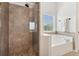 Modern bathroom featuring a glass-enclosed shower and a separate soaking tub with ceramic tile details at 3975 Silverthorn Trce, Cumming, GA 30028
