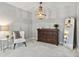 Stylishly decorated bedroom with a large dresser, a full-length mirror, and an elegant chandelier at 3975 Silverthorn Trce, Cumming, GA 30028