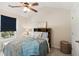 Cozy bedroom with a ceiling fan, a window with blue blinds and a sign above the headboard at 3975 Silverthorn Trce, Cumming, GA 30028