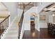 Elegant foyer showcasing a staircase with wooden handrails and a view into the adjacent dining and living spaces at 3975 Silverthorn Trce, Cumming, GA 30028