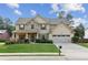 Charming two-story home featuring stone accents, manicured lawn, and a welcoming front porch at 3975 Silverthorn Trce, Cumming, GA 30028