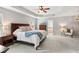 Spacious main bedroom featuring tray ceilings, a ceiling fan, and an en-suite bathroom at 3975 Silverthorn Trce, Cumming, GA 30028