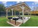 Outdoor grill under a covered area with picnic tables for residents to enjoy at 3975 Silverthorn Trce, Cumming, GA 30028