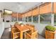 Bright sunroom with wooden dining table and chairs, surrounded by windows and natural light at 3975 Silverthorn Trce, Cumming, GA 30028