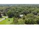 Aerial view of a white home and beautiful grounds with mature trees at 5809 Warren Farm Sw Rd, Powder Springs, GA 30127
