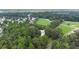 Aerial view highlighting a home nestled among trees and green fields in a suburban neighborhood at 5809 Warren Farm Sw Rd, Powder Springs, GA 30127