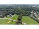 Aerial view of a neighborhood showcasing large lots, mature trees, and green fields at 5809 Warren Farm Sw Rd, Powder Springs, GA 30127