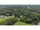 Overhead view of a home surrounded by trees and a large green field at 5809 Warren Farm Sw Rd, Powder Springs, GA 30127