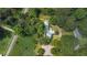 Aerial view of home with mature trees, and long driveway in a rural setting surrounded by woods at 5809 Warren Farm Sw Rd, Powder Springs, GA 30127