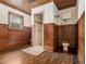 Bathroom features wood paneled walls and floors and a water closet with vintage toilet at 5809 Warren Farm Sw Rd, Powder Springs, GA 30127